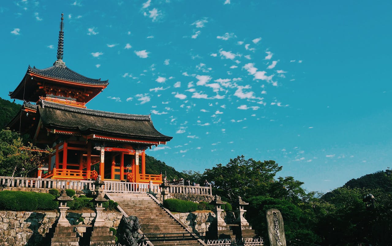 services-img Beautiful view of Kiyomizu Dera Temple in Kyoto, showcasing traditional Japanese architecture under a vibrant sky.